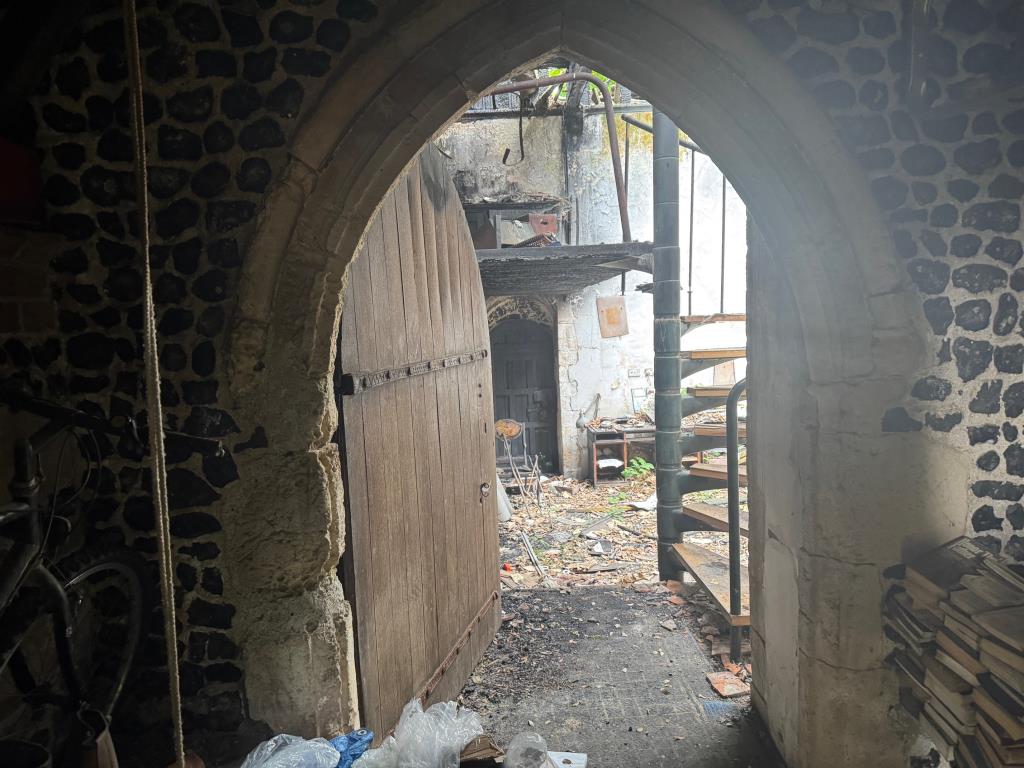 Lot: 178 - FIRE DAMAGED PERIOD LISTED CHURCH - Photo taken through the main doors